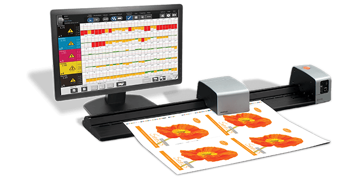 The second version of IntelliTrax2 color scanner, a long grey and black product with the desktop computer behind it showing a software.